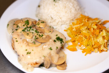 Close up photo of mixed dish of rice with meat garnished by mushroom sauce