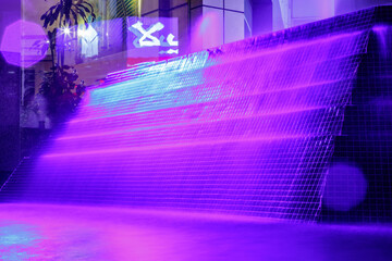Beautiful purple illuminated fountain at night in Dubai
