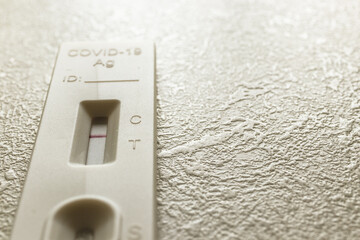 Negative Covid Rapid Antigen test. COVID-19 Ag Test on the table in the dark room.