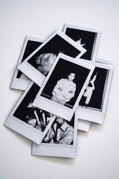 Stack of polaroid photographs on white background