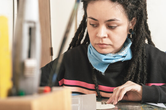 Young White Girl Latino Hispanic Art Director Sitting At Her Desk Working On Her Desk