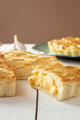 Brazilian Chicken Pie -  Homemade Chicken Pie on Spatula on a Wooden Table Rustic Appeal