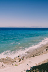 Beautiful landscape view on sea or ocean with sand, sky and waves. Retro styles background