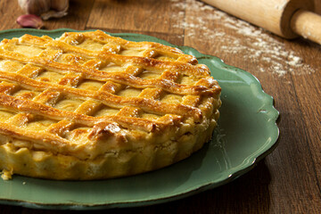 Brazilian Chicken Pie -  Homemade Chicken Pie on Spatula on a Wooden Table Rustic Appeal