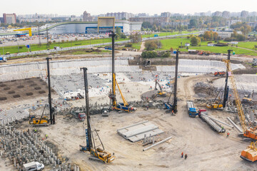 Huge excavation and foundation construction, drilling piles in urban development, aerial view.