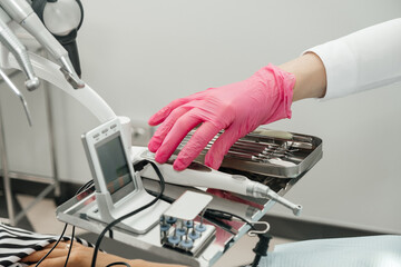 Dental equipment. The work of a dentist. Hands in gloves. The concept of hygiene and sanitation. An unrecognizable person.