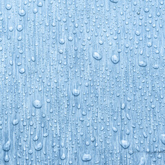 Water drops on metal, blue background. May used as background