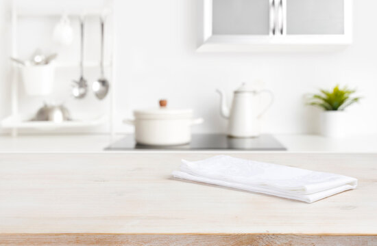White napkin on table with blurred kitchen cooking zone background