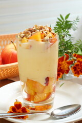 Dessert with ricotta, peach, apple and walnuts on a white plate