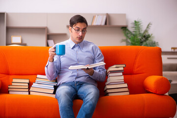 Young male student preparing for exams at home