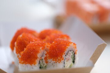 Sushi with flying fish roe lying on table closeup