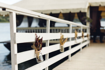 Autumn decor in brown and white colors on waterfront restaurant