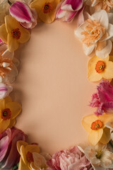 Aesthetic background with colourful flowers. Beautiful floral template composition. Round wreath frame with blank empty copy space mock up background. Flat lay, top view