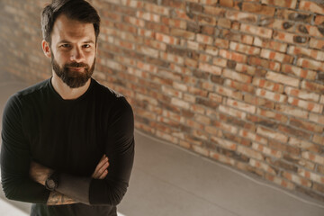 Mid aged bearded sportsman wearing smartwatch