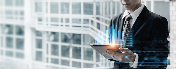 Businessman using tablet computer for analysis chart data of stock market