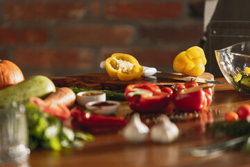 Close-up view of fresh vegetables on huge wooden table in cafe, restaurant kitchen. Concept of a correct, healthy diet.