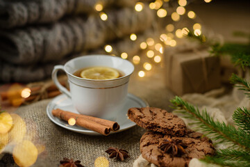 Cup of tea with lemon and cookies close-up with selective focus.