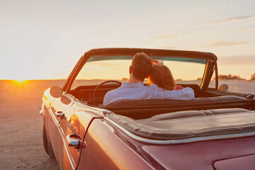 luxury, romantic couple in vintage classic cabriolet car at sunset - obrazy, fototapety, plakaty