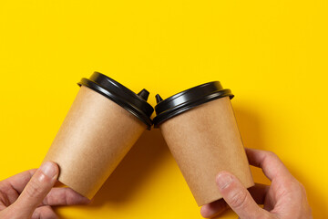 two blank gray paper cups with a plastic black lid