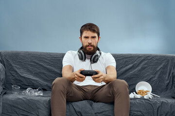 Man sitting on the couch playing fun and rest
