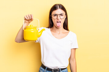 young hispanic woman feeling disgusted and irritated and tongue out. teapot concept