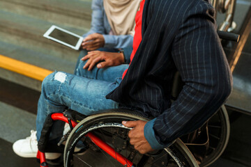 Fototapeta na wymiar Woman and disabled man using tablet computer together