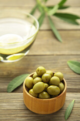 Olive oil with olive on grey background with copy space. Vertical photo