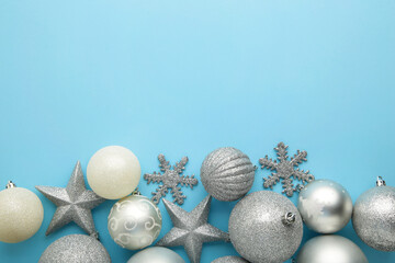 Christmas silver baubles on blue background. New Year composition