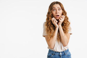 Young ginger woman gesturing while expressing surprise at camera