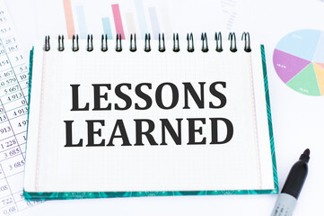 Lessons learned text concept write on notebook on office desk