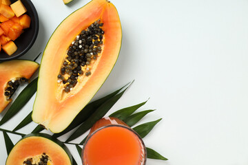 Fresh ripe papaya on white table, space for text