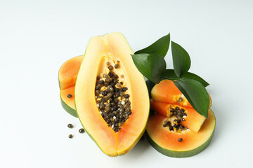Fresh ripe papaya with leaves on white background