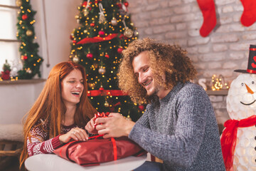 Couple wrapping Christmas presents