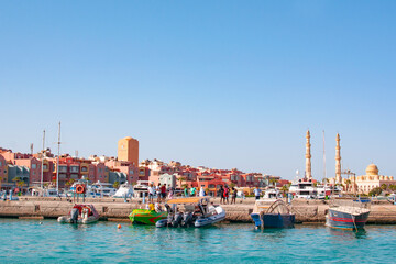 Obraz premium HURGHADA, EGYPT - September 22, 2021 : Mosque El Mina Masjid and the marina with the ships in Hurghada in sunny day, view from the sea.