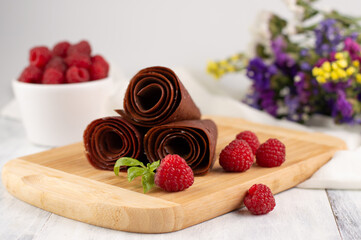 Blurred image of raspberry and berry pastilles on a light background.