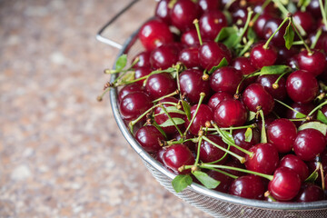 Cherries in a steel sieve. top view, texture