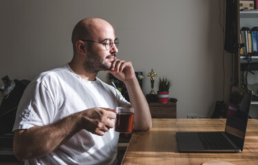Young man taking a tea break while working at home. young man working from his home.