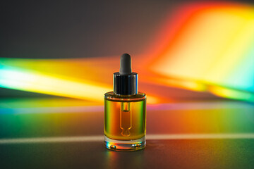 Face oil in front of rainbow