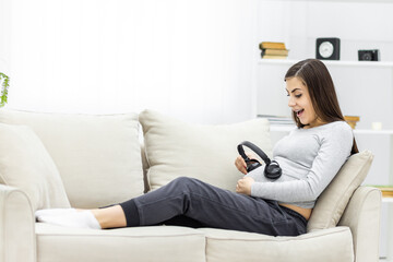 Photo of young pregnant woman with headphones