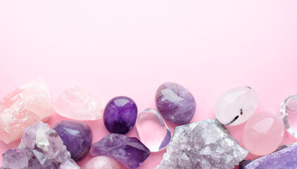 Beautiful gemstones and druses of natural purple mineral amethyst on a pink background. Amethysts...