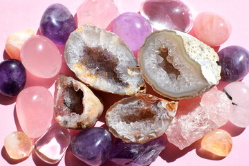 Beautiful gemstones,  geode amethyst and druses of natural purple mineral amethyst on a pink...