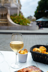 Drinking of brut champagne sparkling wine in street cafe in old central part of city Reims, Champagne, France