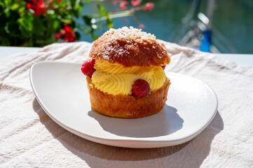 Tarte tropezienne or La Tarte de Saint-Tropez - dessert pastry consisting of filled brioche with cream and fresh berries.