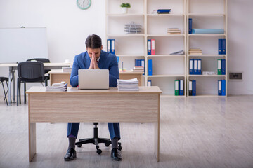 Young attractive employee working in the office