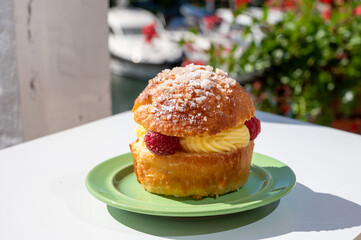 Tarte tropezienne or La Tarte de Saint-Tropez - dessert pastry consisting of filled brioche with cream and fresh berries.