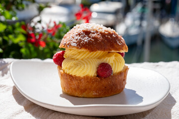 Tarte tropezienne or La Tarte de Saint-Tropez - dessert pastry consisting of filled brioche with cream and fresh berries.