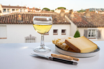 Cheese collection, hard French cheese comte made from cow milk with rind in Franche-Comte regio and emmentaler cheese, France, served with white wine