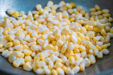 Fresh Sweet Corn Grains separating from the corncob .