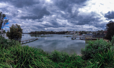 Fototapeta premium Houses, boats, wharfs, Trees and flowers on Sydney George River mouth at Tom Uglys Bridge NSW Australia. 