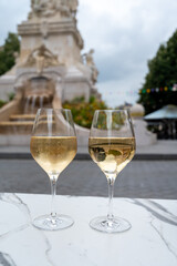 Drinking of brut champagne sparkling wine in street cafe in old central part of city Reims, Champagne, France